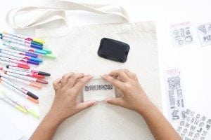 Use a few supplies to create a customized diy stamped canvas tote bag that you can color with fabric markers