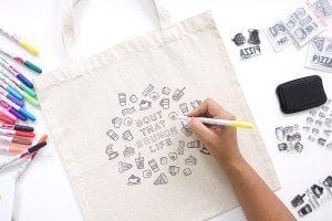 Use a few supplies to create a customized diy stamped canvas tote bag that you can color with fabric markers