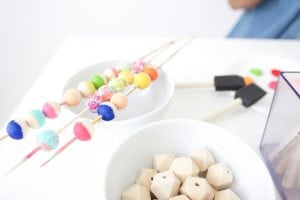 Grab some paint and learn how to paint wooden beads in a variety of different patterns..