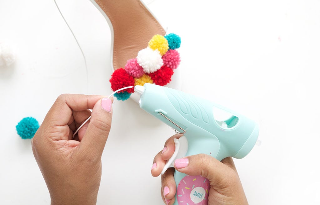 recreate this seasons hottest footwear by making your own DIY pom pom sandals. They will turn heads and save you a ton of money!