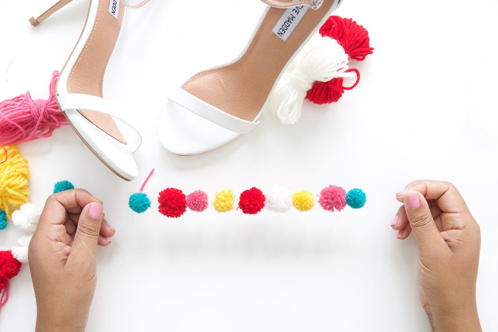 recreate this seasons hottest footwear by making your own DIY pom pom sandals. They will turn heads and save you a ton of money!