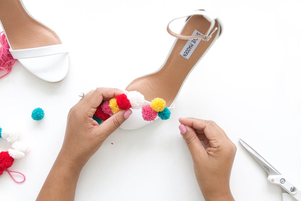 recreate this seasons hottest footwear by making your own DIY pom pom sandals. They will turn heads and save you a ton of money!