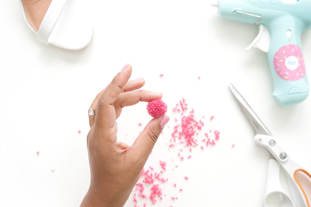 recreate this seasons hottest footwear by making your own DIY pom pom sandals. They will turn heads and save you a ton of money!