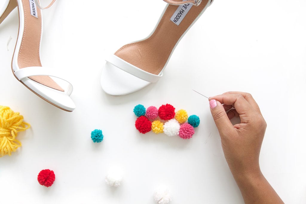 recreate this seasons hottest footwear by making your own DIY pom pom sandals. They will turn heads and save you a ton of money!