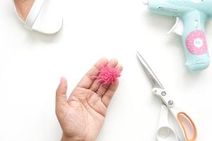 recreate this seasons hottest footwear by making your own DIY pom pom sandals. They will turn heads and save you a ton of money!