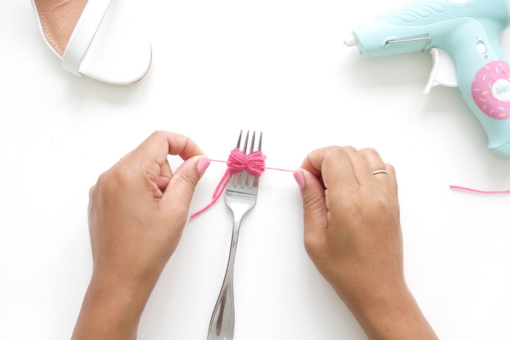 recreate this seasons hottest footwear by making your own DIY pom pom sandals. They will turn heads and save you a ton of money!