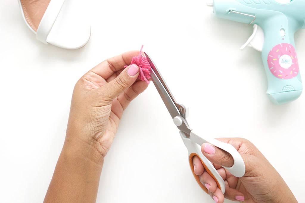 recreate this seasons hottest footwear by making your own DIY pom pom sandals. They will turn heads and save you a ton of money!