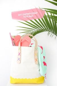 Transform a regular canvas tote bag into a DIY Leather Strap Tote Bag with the addition of leather and a few basic crafting supplies.ban