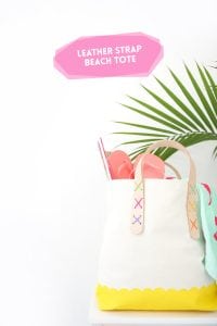 Transform a regular canvas tote bag into a DIY Leather Strap Tote Bag with the addition of leather and a few basic crafting supplies.