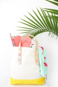 Transform a regular canvas tote bag into a DIY Leather Strap Tote Bag with the addition of leather and a few basic crafting supplies.