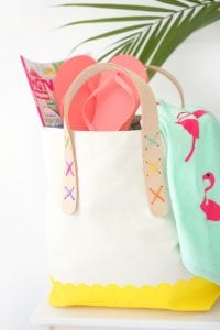Transform a regular canvas tote bag into a DIY Leather Strap Tote Bag with the addition of leather and a few basic crafting supplies.