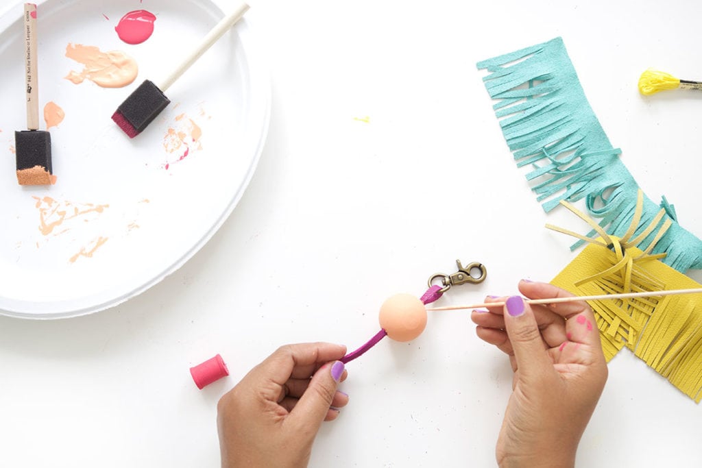 Tassels will never go out of style so why not create these leather and wood bead tassels in just a few steps.Your tote bag will thank you. 