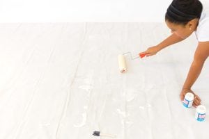 Large area rugs can be pricey! Follow this tutorial on how to turn a regular piece of fabric into a DIY Mod Podge Fabric Rug. It's totally customizable and afforable.