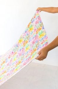 Large area rugs can be pricey! Follow this tutorial on how to turn a regular piece of fabric into a DIY Mod Podge Fabric Rug. It's totally customizable and afforable.