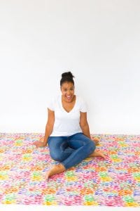 Large area rugs can be pricey! Follow this tutorial on how to turn a regular piece of fabric into a DIY Mod Podge Fabric Rug. It's totally customizable and afforable.