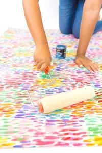 Large area rugs can be pricey! Follow this tutorial on how to turn a regular piece of fabric into a DIY Mod Podge Fabric Rug. It's totally customizable and afforable.