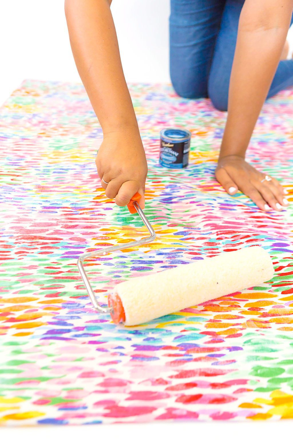Large area rugs can be pricey! Follow this tutorial on how to turn a regular piece of fabric into a DIY Mod Podge Fabric Rug. It's totally customizable and afforable. 