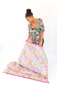 Large area rugs can be pricey! Follow this tutorial on how to turn a regular piece of fabric into a DIY Mod Podge Fabric Rug. It's totally customizable and afforable.
