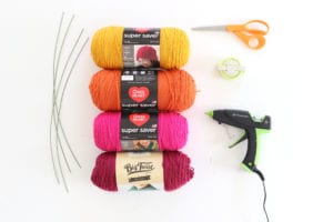 Use yarn, pom pom maker, hot glue and floral wire to create pom pom flowers