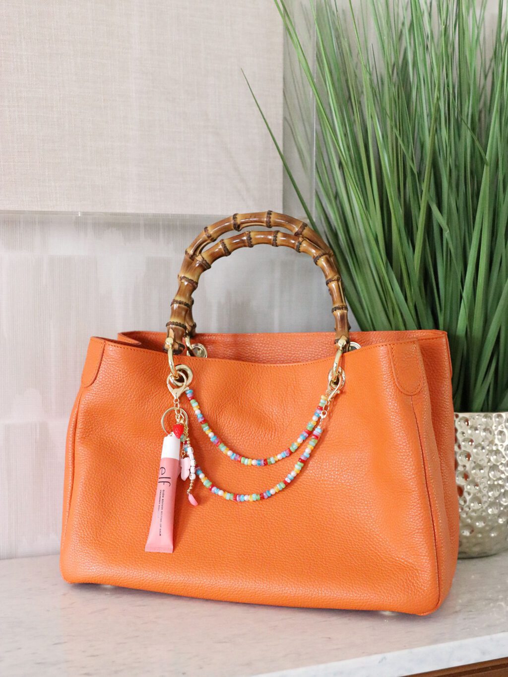 orange bamboo handbag with bag charm